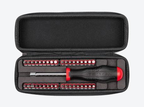 A Tekton 1/4 Inch Drive Magnetic Bit Driver and bit sets on rails in an open black case.